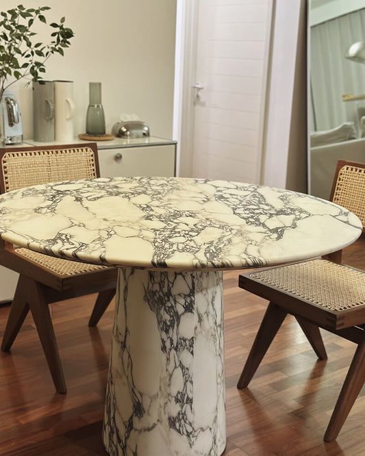 Calacatta Viola round dining table with a central pedestal