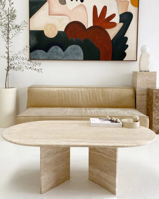 Beige travertine V-shaped coffee table in a living room