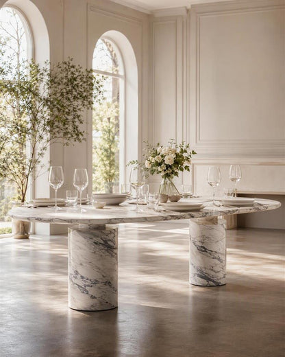 Arabescato oval dining table styled with plates and glassware