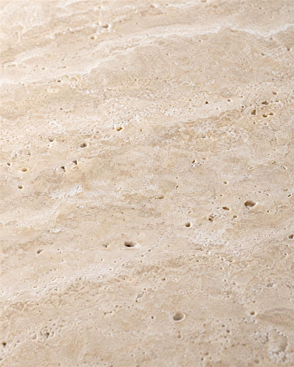 Close-up of beige travertine natural pores and subtle stone veining