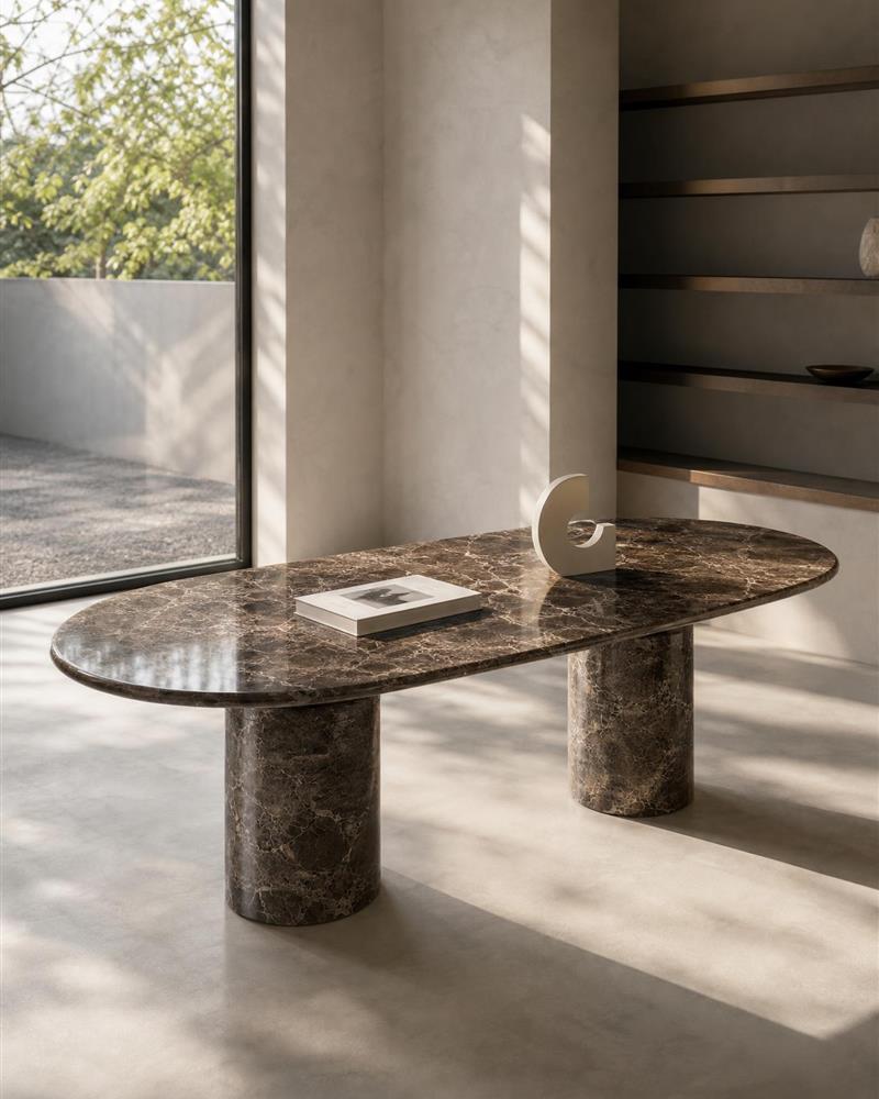 Emperador oval dining table styled with a book and sculpture