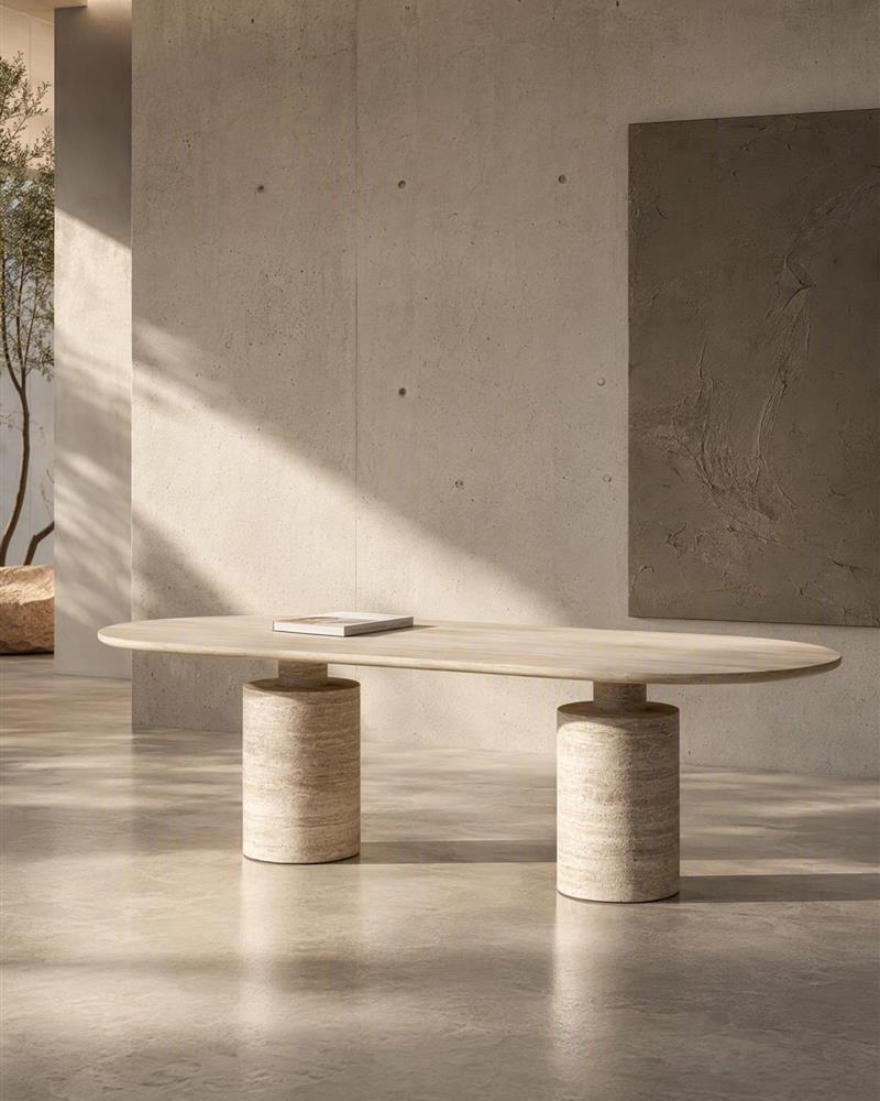 Beige travertine oval dining table in a calm gallery interior