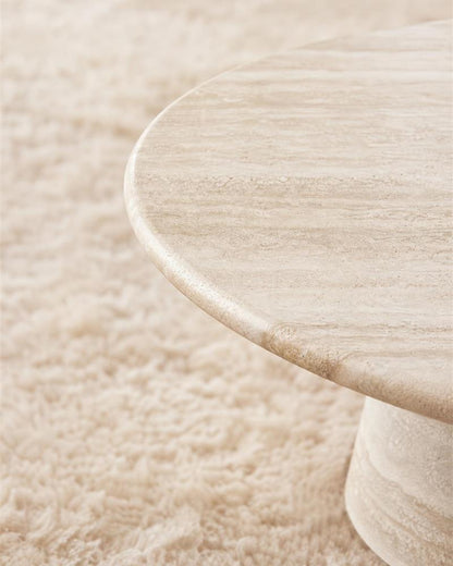 Close-up of the rounded edge and natural beige travertine veining
