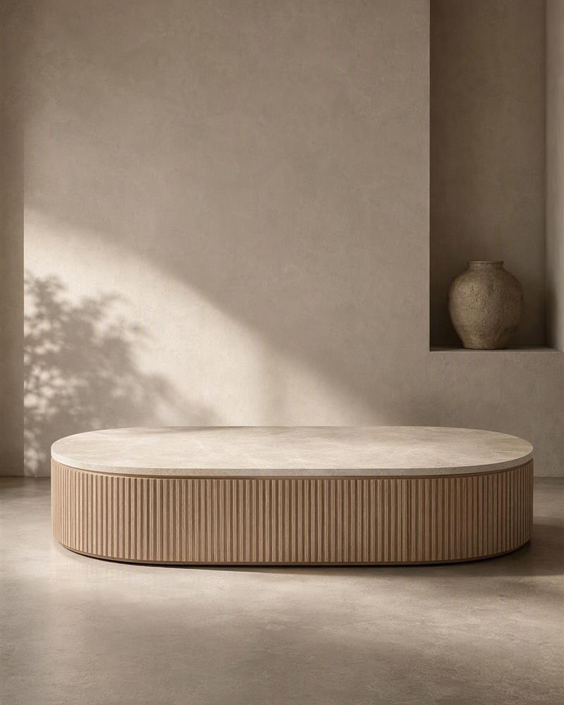 Oval Taj Mahal coffee table with fluted wooden base in warm natural light