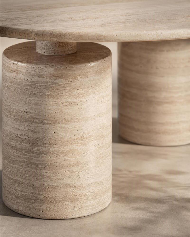 Close-up of beige travertine stepped cylindrical pedestal and tabletop