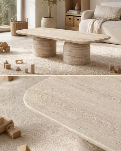 Beige travertine double pedestal coffee table and rounded stone edge close-up