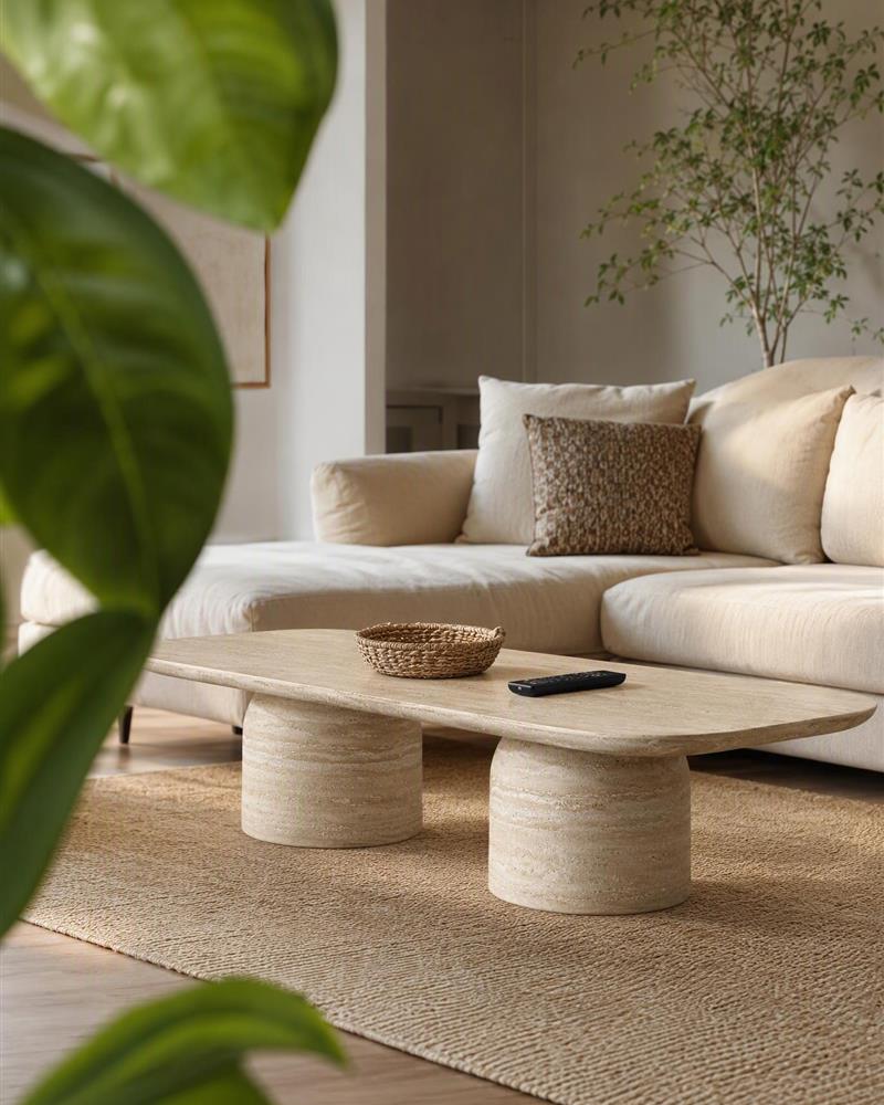 Double pedestal travertine coffee table in a neutral living room