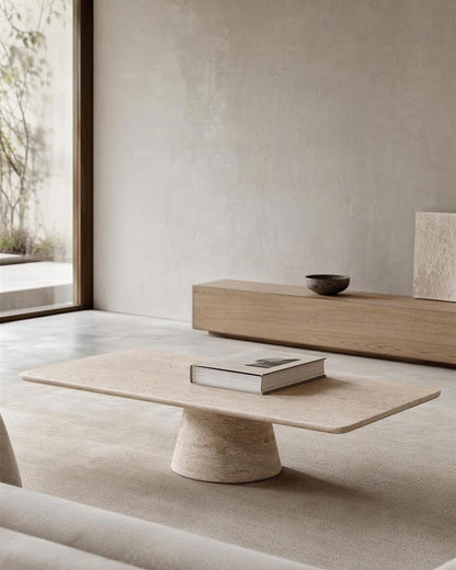 Beige travertine coffee table with conical base in a minimalist living room